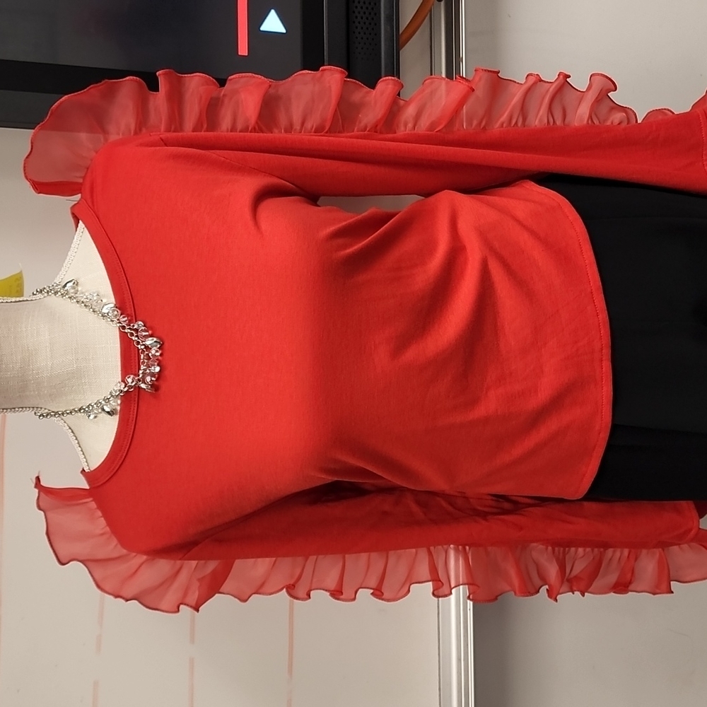 Red spandex shirt with ruffled sleeve. Runs small so if you wear XL it will fit.